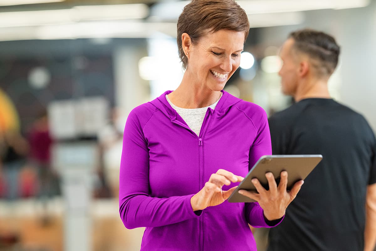Fitness studio owner managing scheduling and memberships through fitness management software