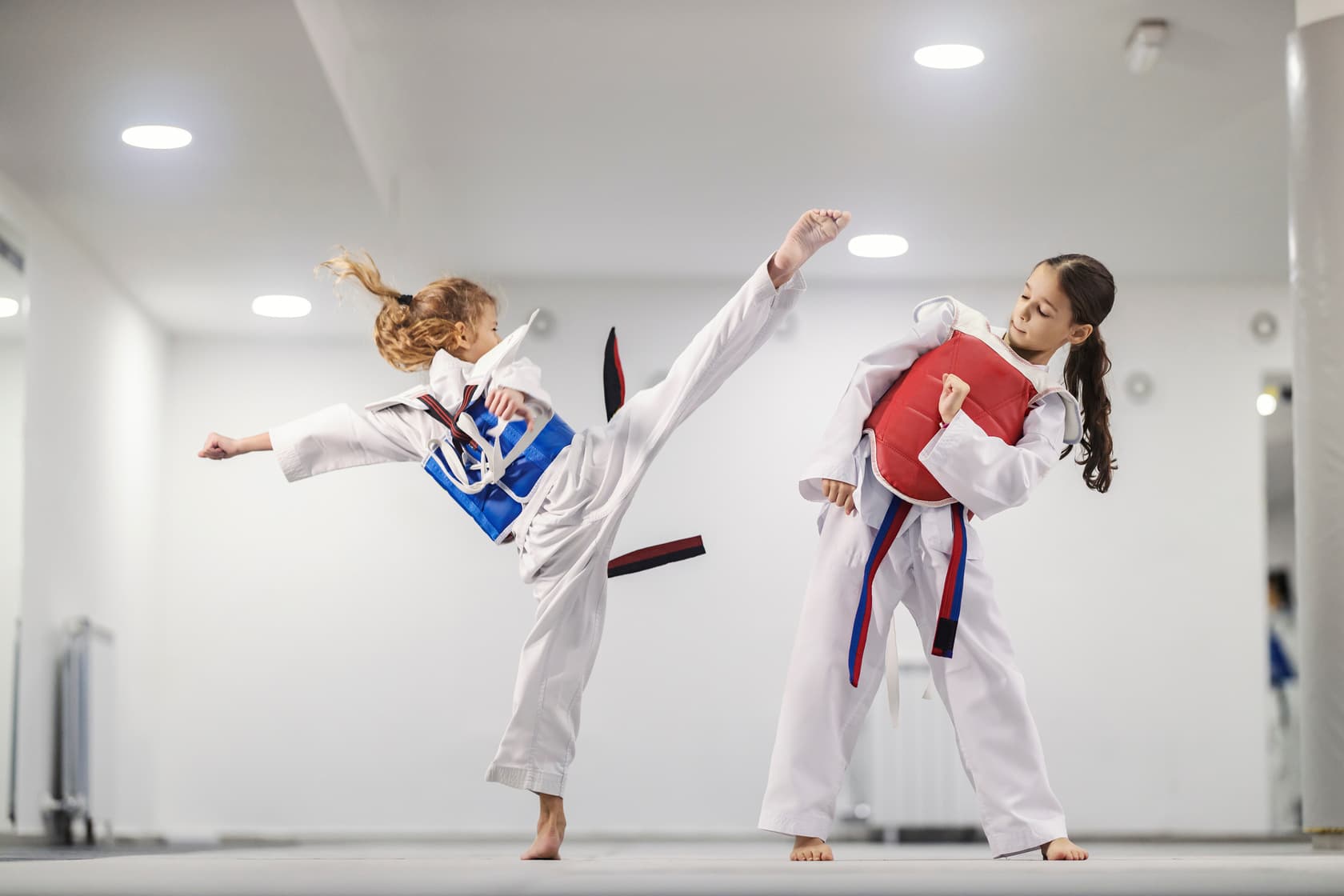 Little girls practicing combat in martial art school