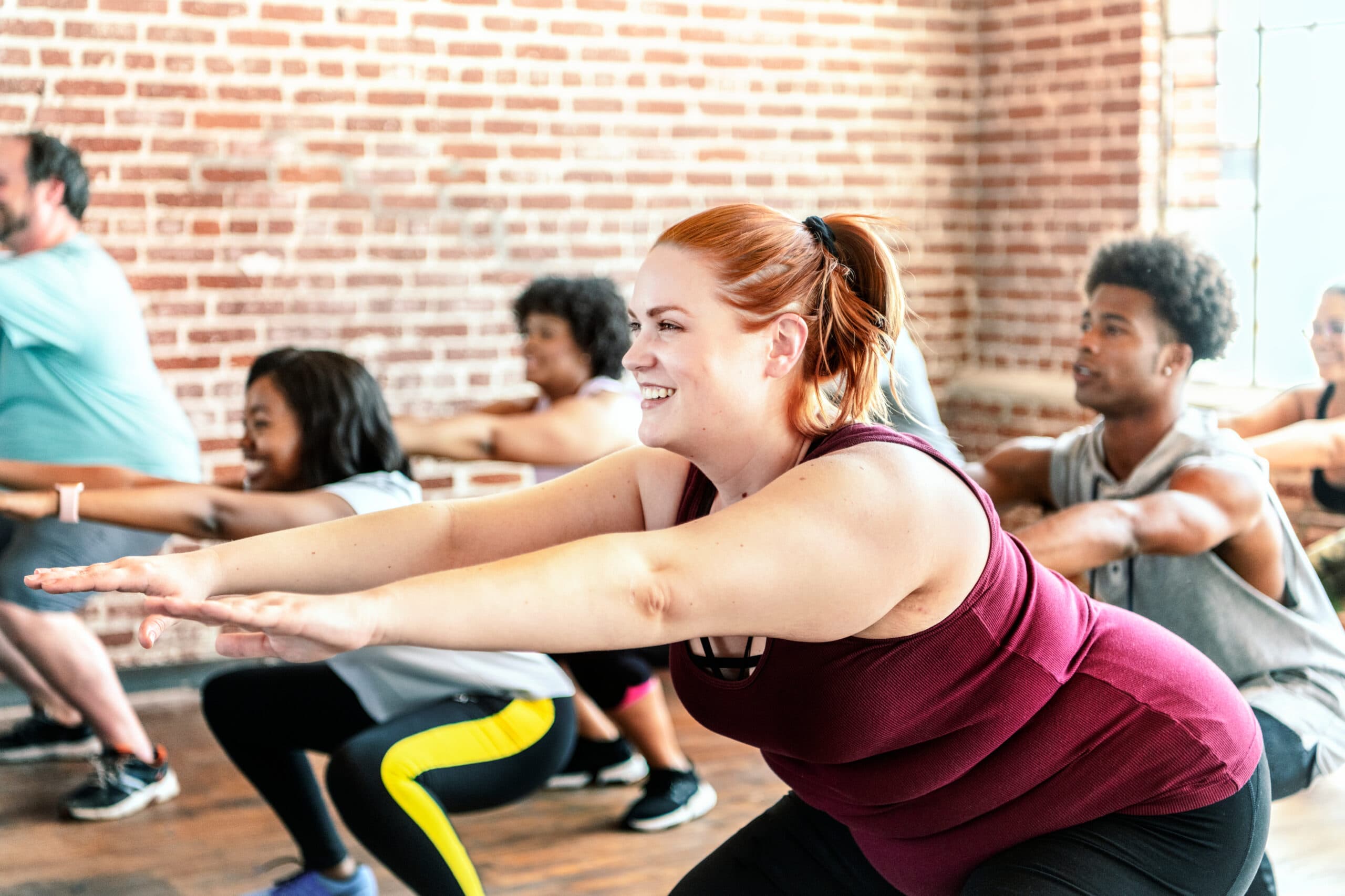 Fitness studio owner planning SMS and email marketing campaigns